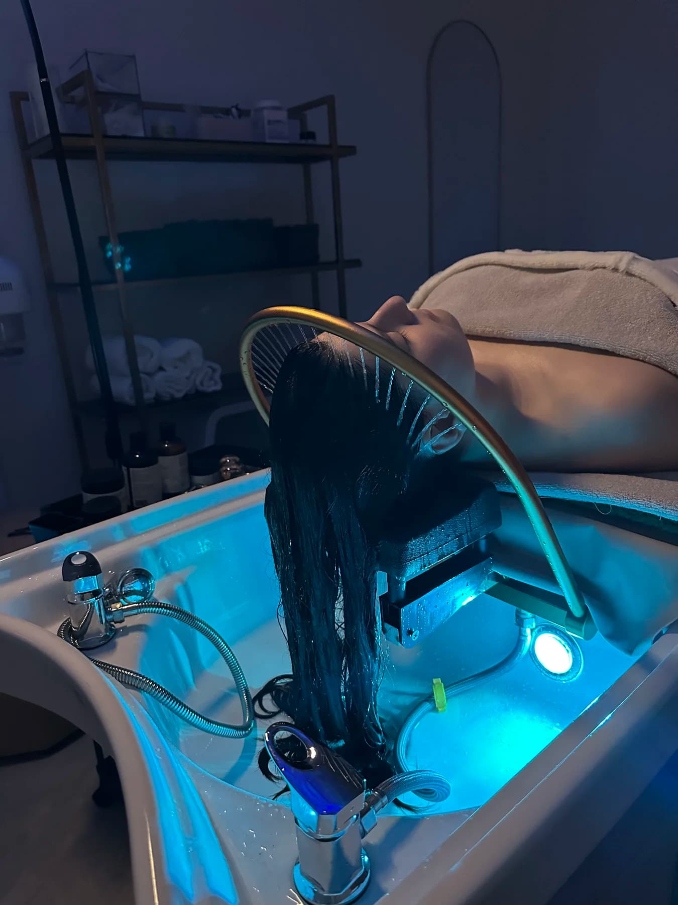Bea applying a gold facial treatment to a guest