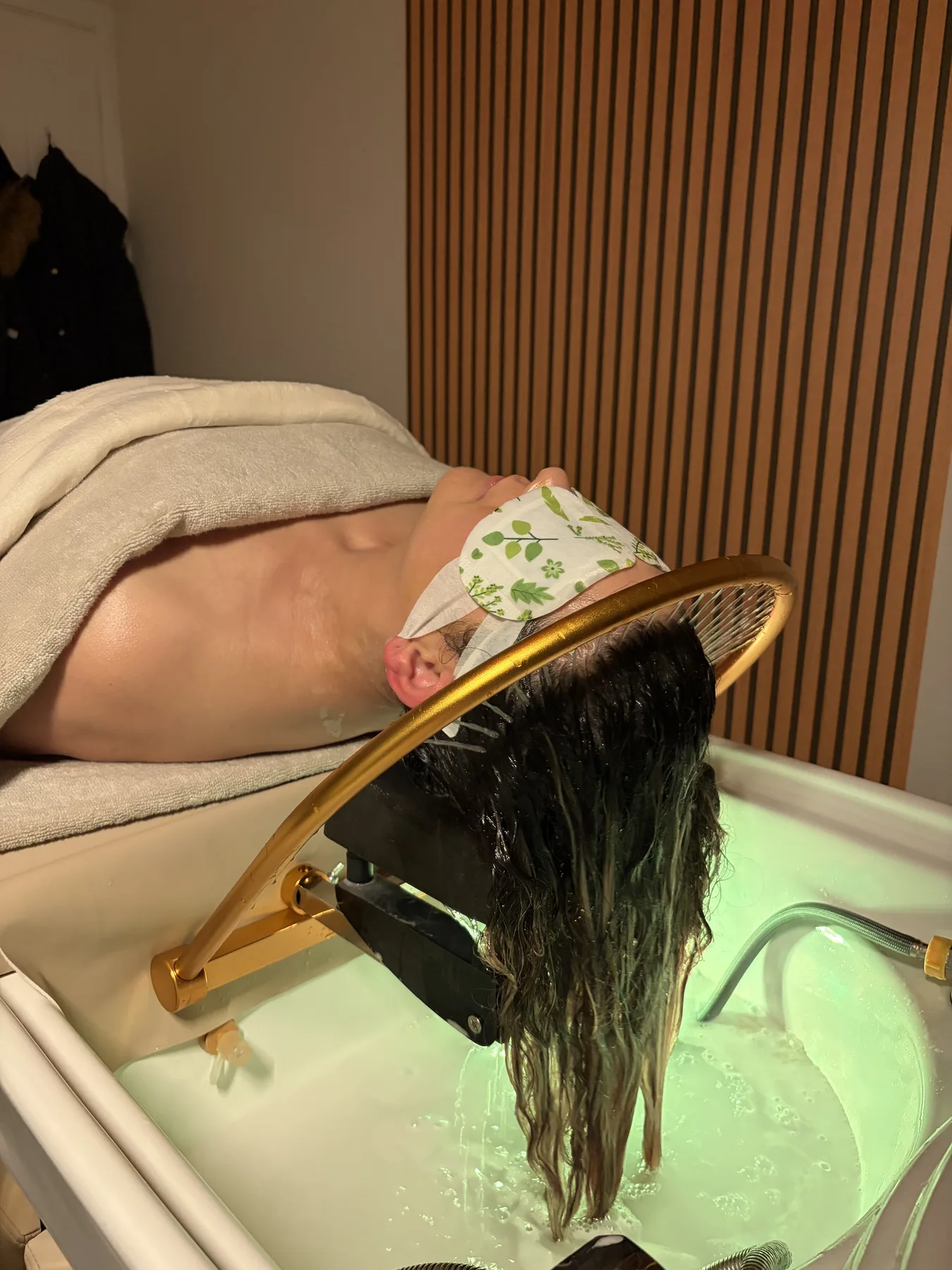 Client resting with a herbal eye mask